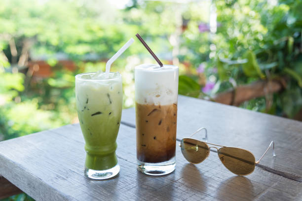 istock ice coffee and green tea on wood table green background 884358976