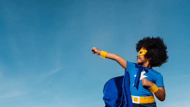 девушка с афро играет супергероя - воспитатель стоковые фото и изображения