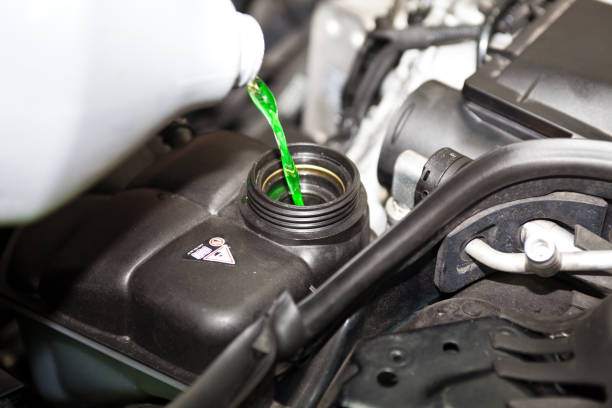 Pouring antifreeze to the car Pouring antifreeze to the car coolant stock pictures, royalty-free photos & images