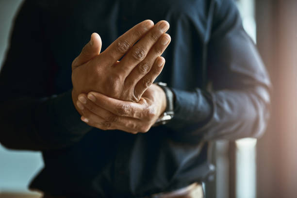 Feeling numbness and pain in his hands Closeup shot of an unidentifiable businessman suffering with pain in his hands carpal tunnel syndrome photos stock pictures, royalty-free photos & images