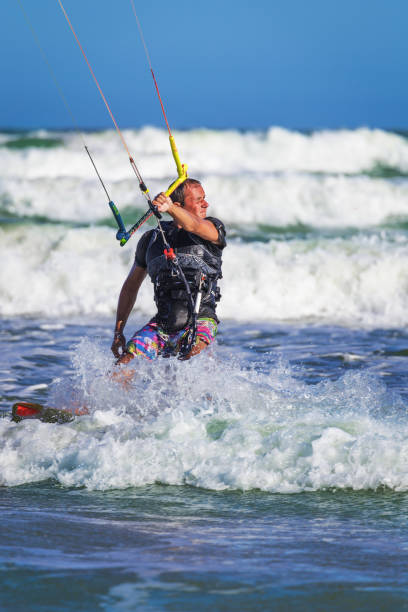 istock Young athletic man riding kite surf on a sea 884374236