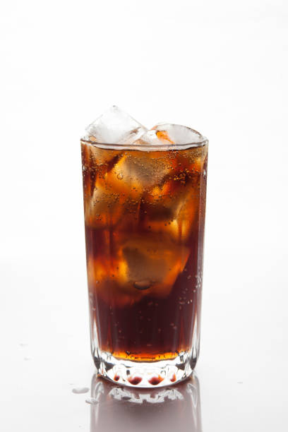 istock Cola with ice in a glass on white background 884374474