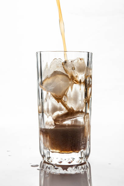 istock Cola Pouring to Glass with ice 884374494