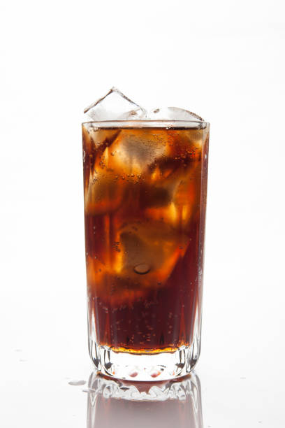 istock Cola with ice in a glass on white background 884374498