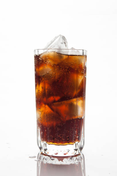 istock Cola with ice in a glass on white background 884374504