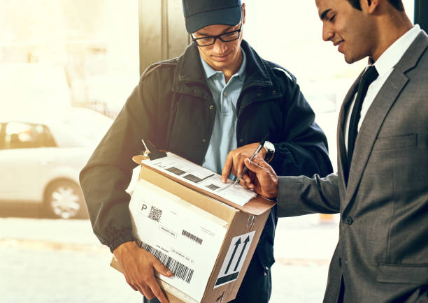 Please mark your name here Shot of a businessman signing for his delivery from the courier invoice pad stock pictures, royalty-free photos & images