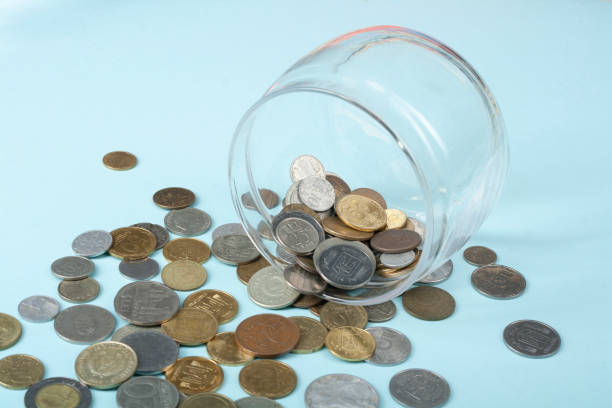 istock Home savings, budget concept. Glass jar and coins on office table. 884378312