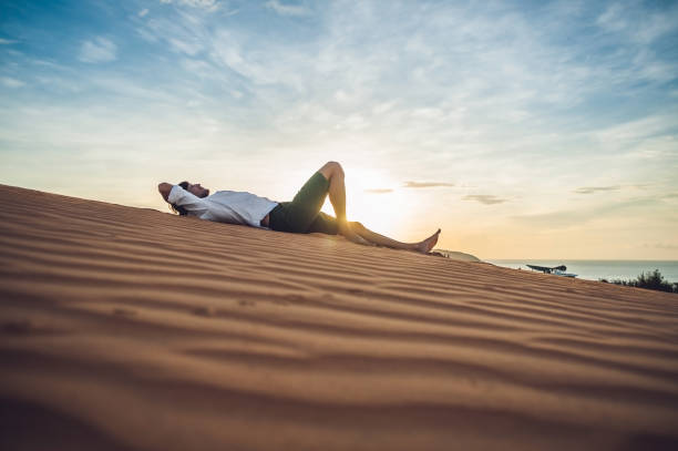 istock A man sits on the sand in the desert 884381386