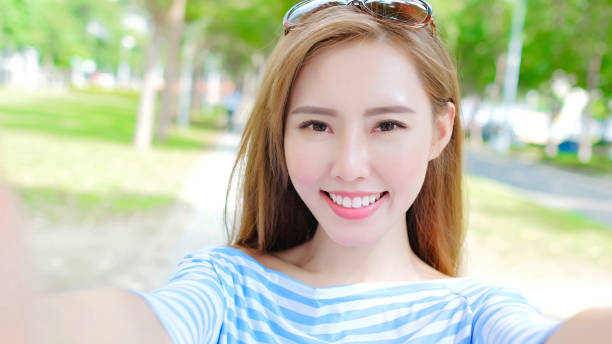 istock woman selfie happily 884384326