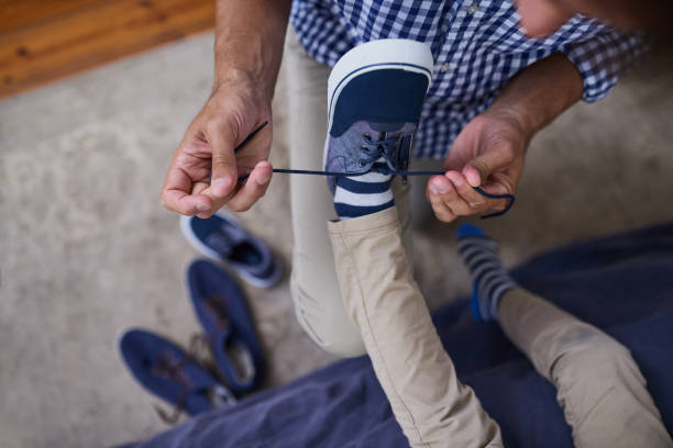istock Helping him with his laces 884387690