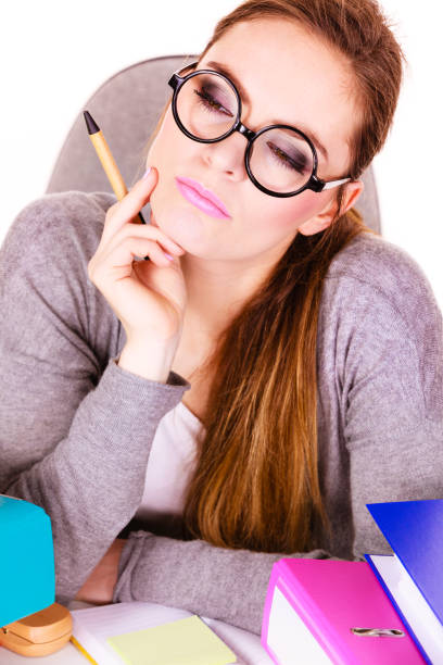 istock Woman sitting at desk in office and thinking 884431132
