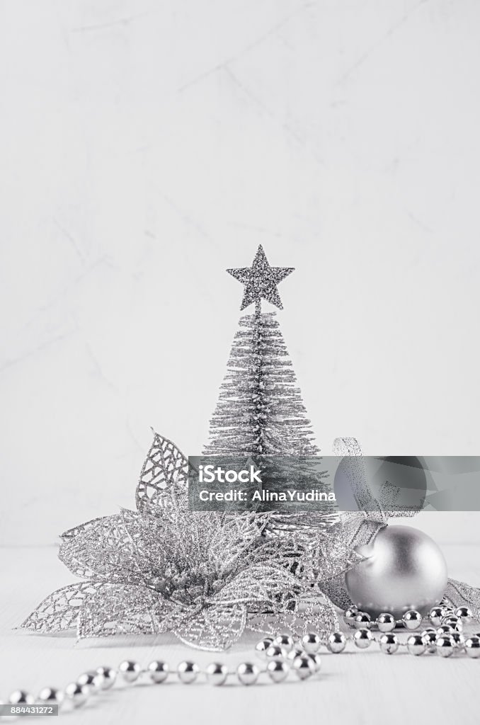 Christmas silver tree and decorations on white soft wood background. Festive interior. Backgrounds Stock Photo