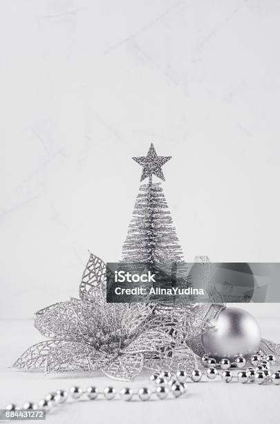 Christmas Silver Tree And Decorations On White Soft Wood Background Festive Interior Stock Photo - Download Image Now