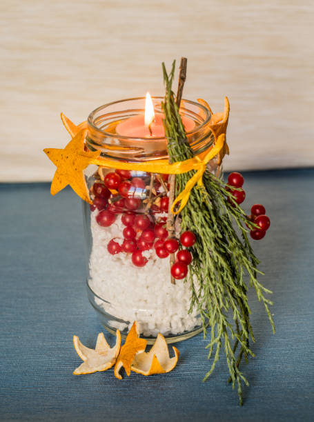 istock christmas hand made candle with red berries craft on the blue tablecloth 884447508