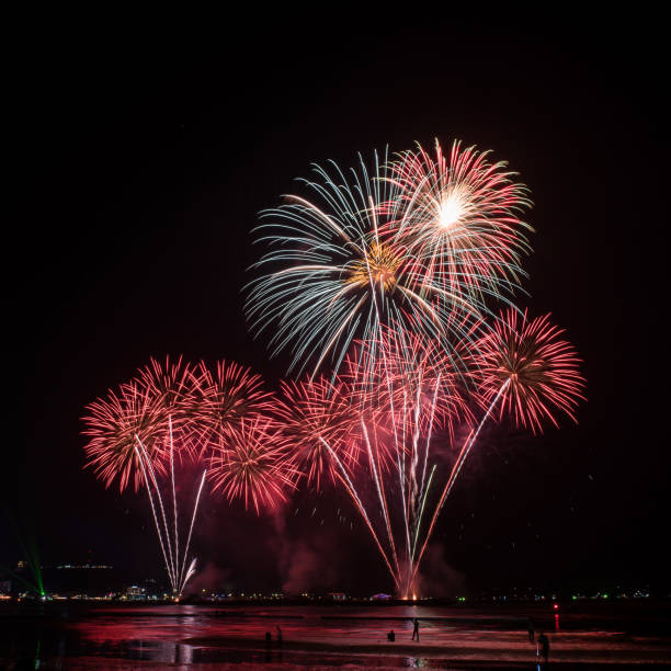 istock Beautiful colorful fireworks display on the water for celebration night 884447908