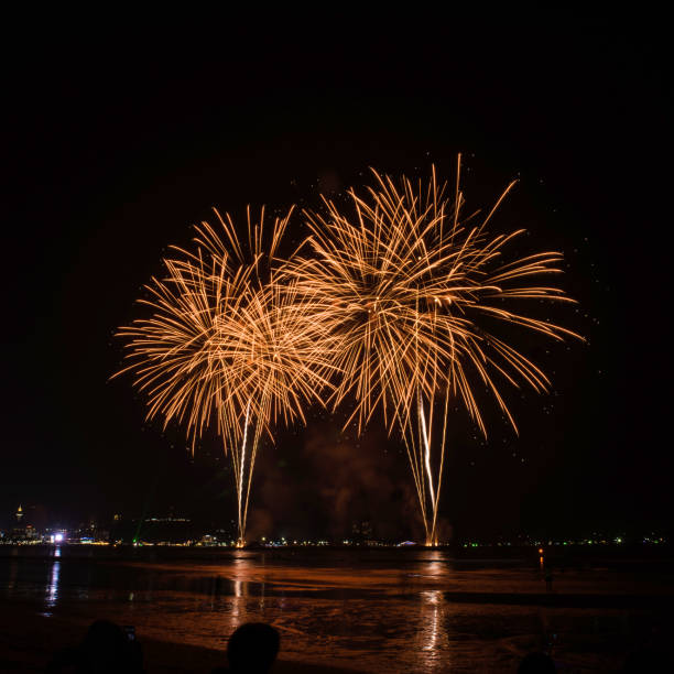 istock Beautiful colorful fireworks display on the water for celebration night 884447924