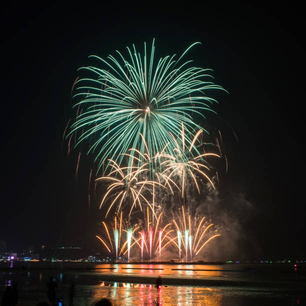 istock Beautiful colorful fireworks display on the water for celebration night 884447938