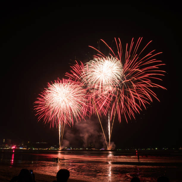 istock Beautiful colorful fireworks display on the water for celebration night 884447944
