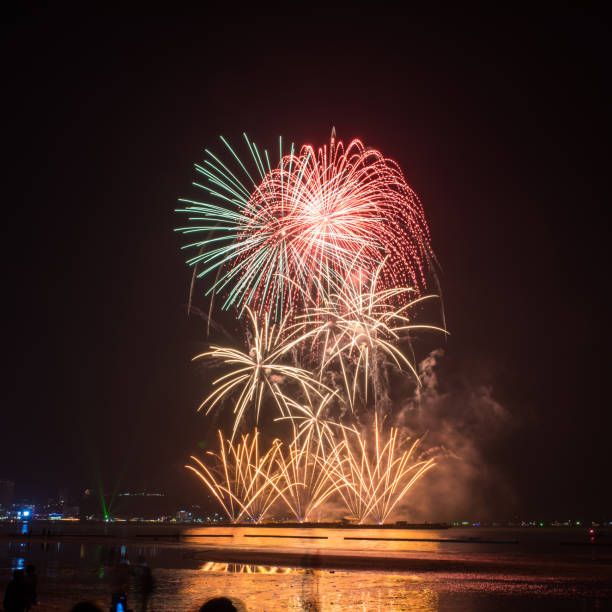istock Beautiful colorful fireworks display on the water for celebration night 884447952