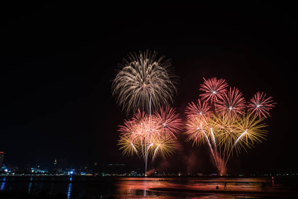 istock Beautiful colorful fireworks display on the water for celebration night 884447956