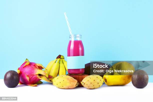 Healthy Lifestyle Concept Pink Smoothie With Tropical Fruits On White Table Stock Photo - Download Image Now