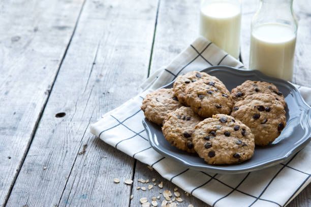 homemade oatmeal cookies with chocolate on an old wooden background stock photo