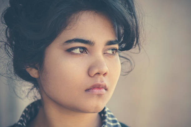 istock Close–up of young woman thinking. 884470646