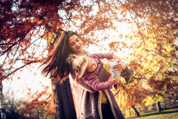 istock Young mother and daughter in park. 884471422