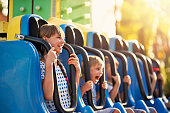 Kids having extreme fun in amusement park drop tower