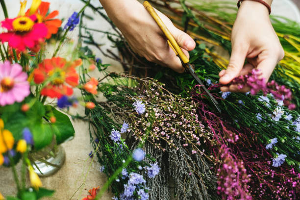 istock Woman arranging and decorating flowers 884471710