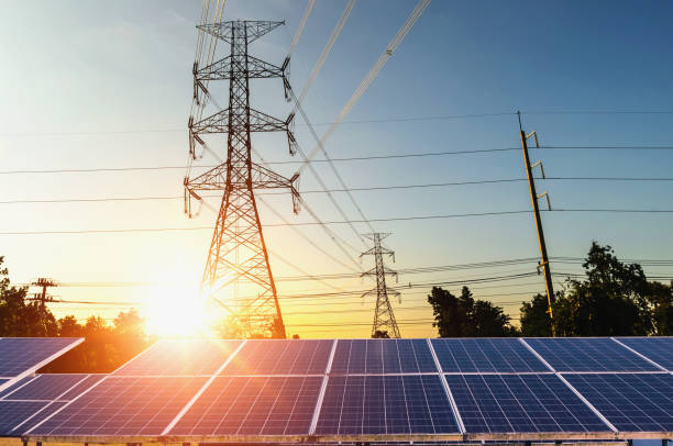 istock Clean power energy concept. electricity pylon with solar panels and sunset 884482528