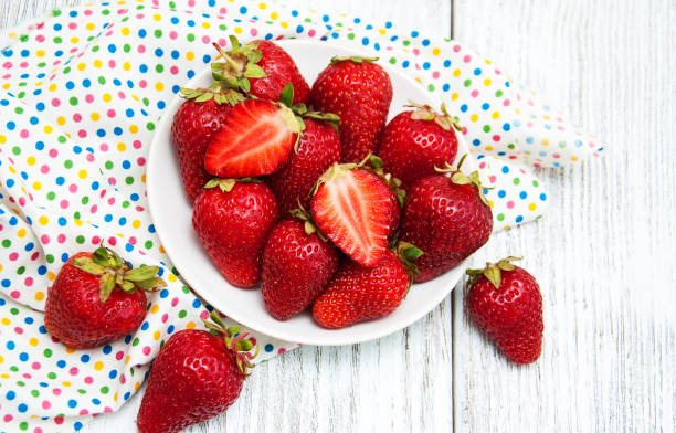 istock ripe strawberries on wooden table 884483454