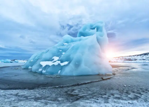 Iceberg lagoon in Fjallsarlon, Iceland. Beautiful sunset light, concept of global warming and ice melting.