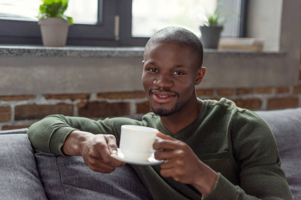istock african american man holding cup 884495530