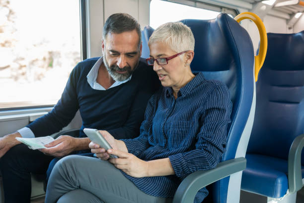 istock Mature couple traveling by train 884498136