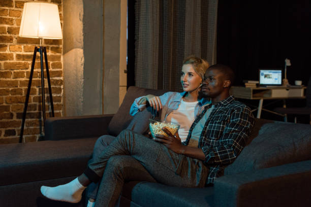 istock couple with popcorn watching film together 884501552