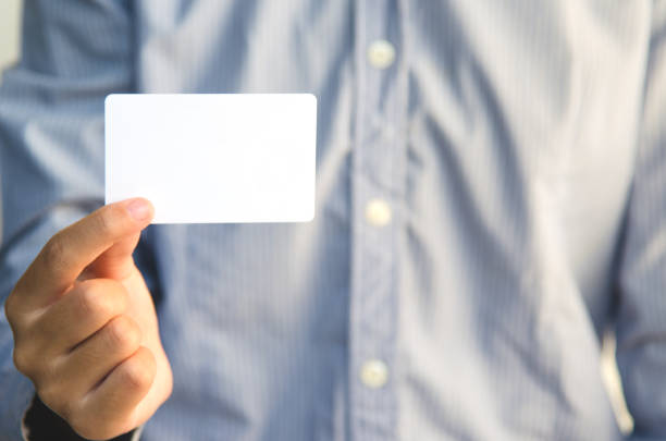 istock Close Up man holding white business card 884503018