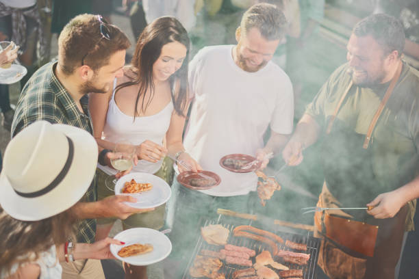 istock Group of people at barbecue party 884503072