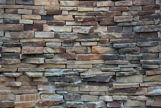 istock Fragment of artistic wall made with multiple stones 884505632