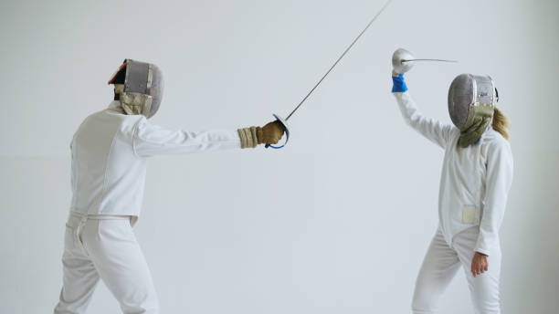 istock Two fencers have fencing training on white background 884521284