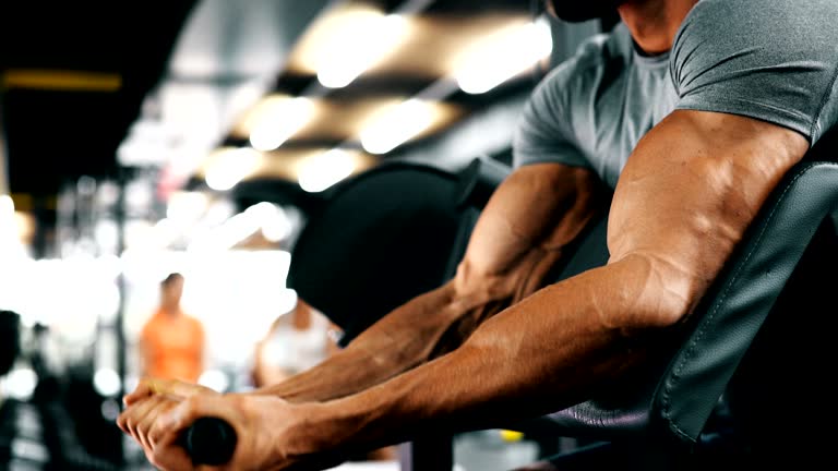 Young handsome man doing exercises in gym