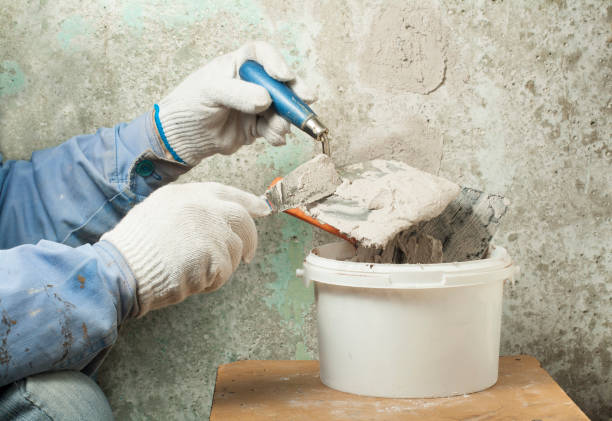 construction and renovation concept. hands of worker in gloves with plastering tools. - plasterer plaster wall dirty imagens e fotografias de stock