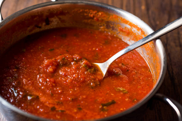 istock Tomato Sauce with Spoon in Metal Pan 884527210