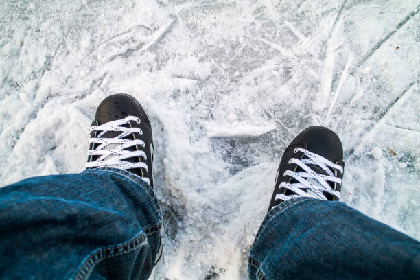 istock Hockey skates on ice 884527658