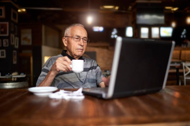 istock Senior man in coffee shop 884528178