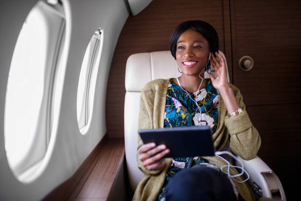 istock Woman in private jet airplane 884528450