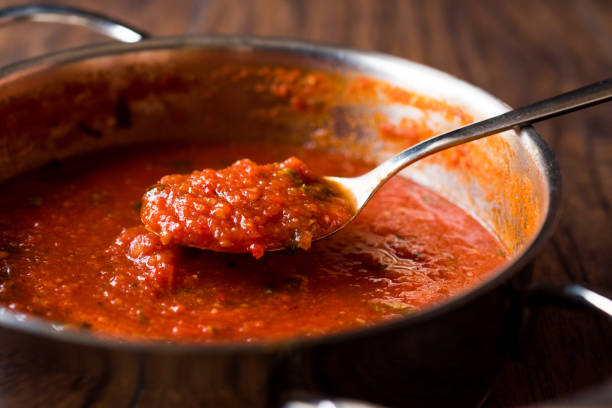 istock Tomato Sauce with Spoon in Metal Pan 884534882