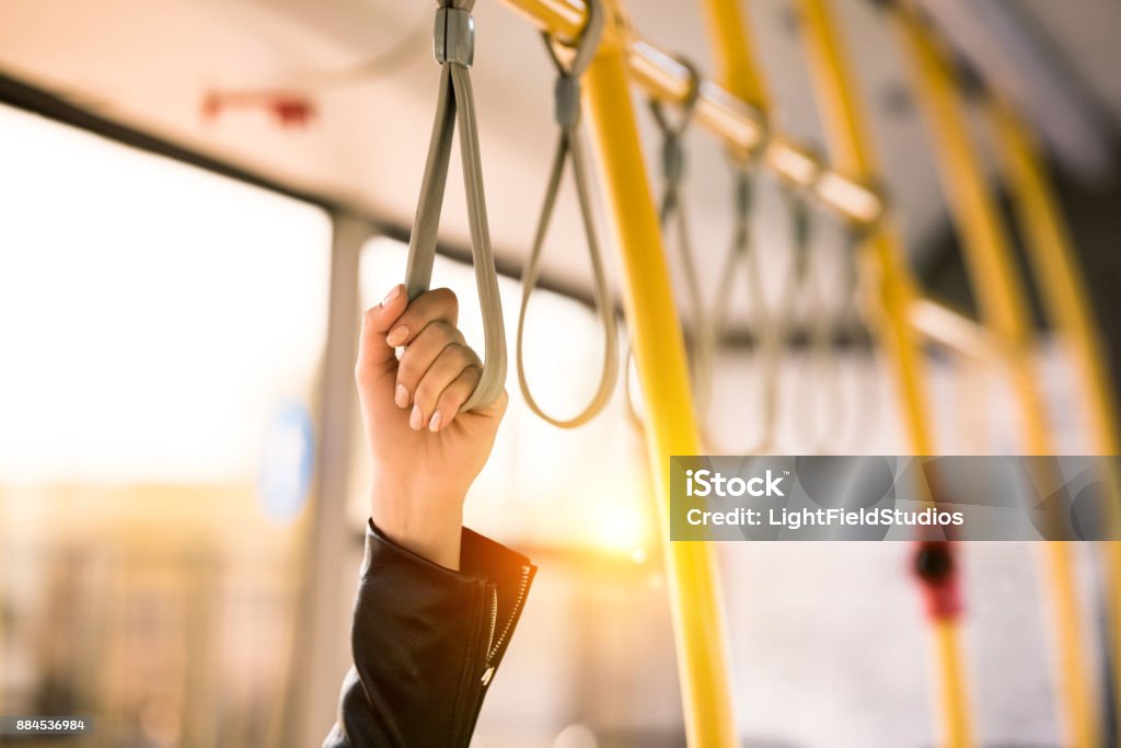 person standing in bus close-up partial view of person standing in city bus Public Transportation Stock Photo