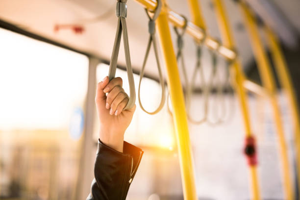 person standing in bus close-up partial view of person standing in city bus public transportation photos stock pictures, royalty-free photos & images