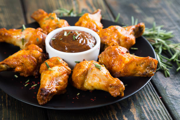 istock Fried chicken wings with spicy sauce 884550138